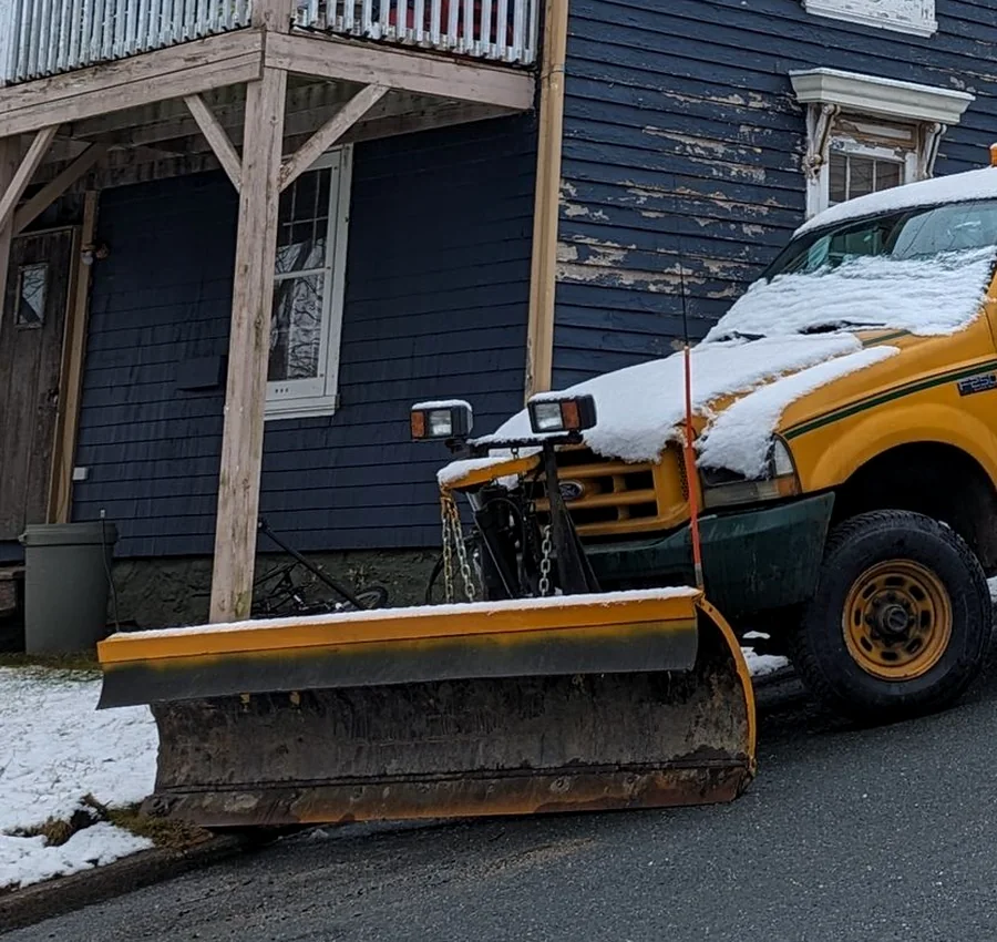 Pickup truck fitted with a snow plow blade after a snowfall